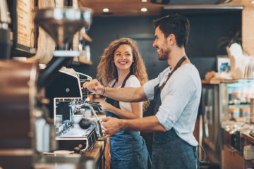 Couple of baristas working in a coffee shop